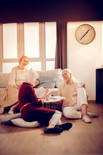 istock Nice aged woman sitting on the floor 1095066522
