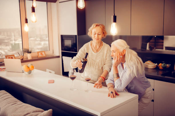 istock Happy elderly woman holding a wine bottle 1095066546