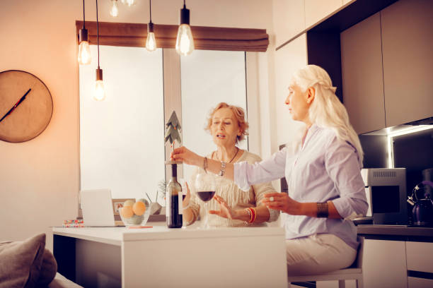 istock Nice aged woman wanting to pour wine 1095066578