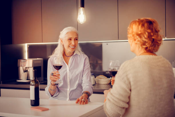 istock Joyful cheerful woman standing with a wine glass 1095066614