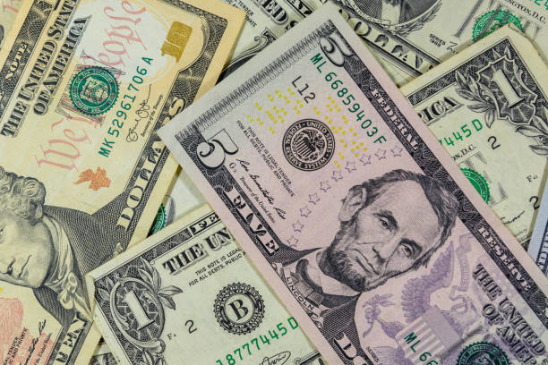 istock Background of different american dollar banknotes 1095068546