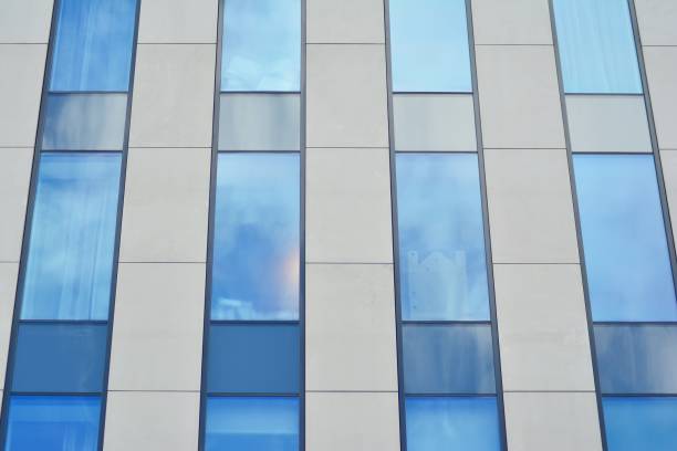 istock Modern building with reflected sky and cloud in glass window 1095068872