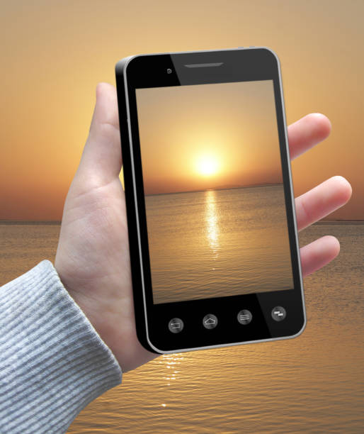 istock modern smartphone with image of sunset above sea on screen in hand 1095069416