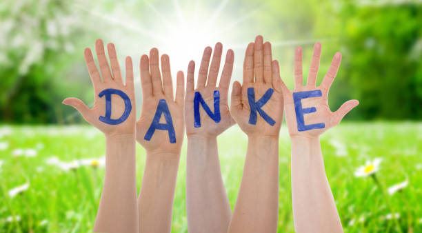 istock Many Hands Building Danke Means Thank You, Sunny Grass Meadow 1095069834
