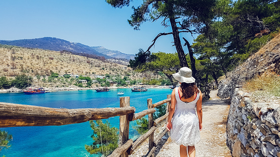 Young woman exploring beautiful Aliki beach in Thasos, Greece