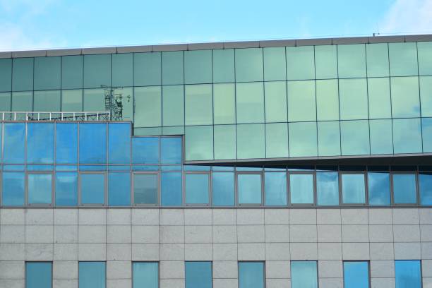 istock Modern building with reflected sky and cloud in glass window 1095071976