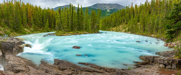 istock Sunwapta Falls with blue water flowing in Spring, Alberta, Canada. 1095074694