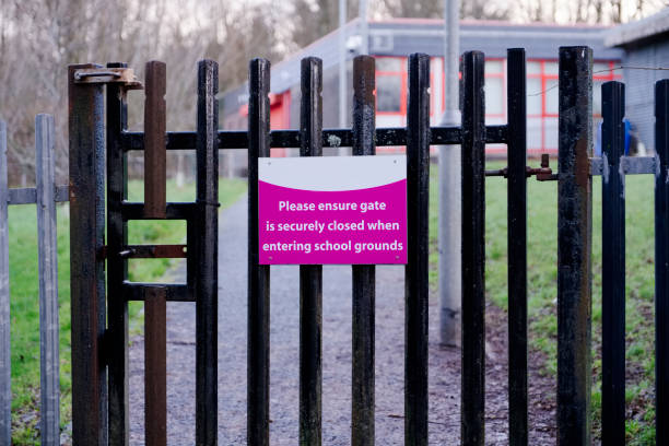 istock School gate to keep shut sign in grounds for security to children 1095074864