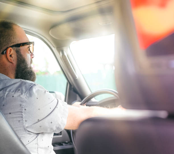istock Man driving a vehicle, cheerful candid image 1095077518