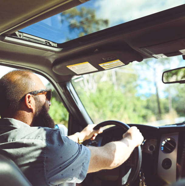 istock Man driving a vehicle, cheerful candid image 1095077664