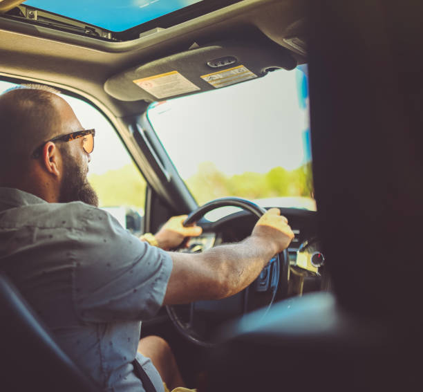 istock Man driving a vehicle, cheerful candid image 1095077792