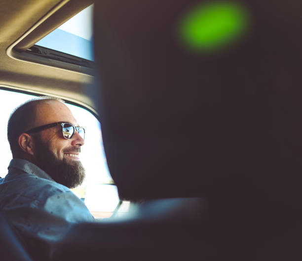 istock Man driving a vehicle, cheerful candid image 1095077818