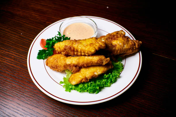 istock Appetizing dish on a white plate stands on a wooden table, food 1095077868