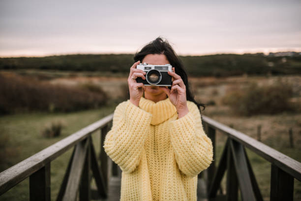 A woman using a vintage camera