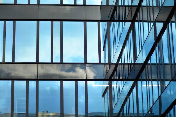 istock Modern building with reflected sky and cloud in glass window 1095078168