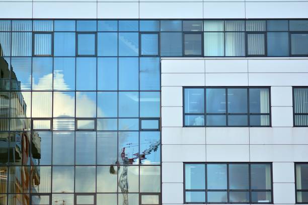 istock Modern building with reflected sky and cloud in glass window 1095080348