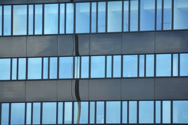 istock Modern building with reflected sky and cloud in glass window 1095080566