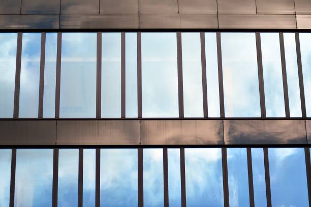 istock Modern building with reflected sky and cloud in glass window 1095080672
