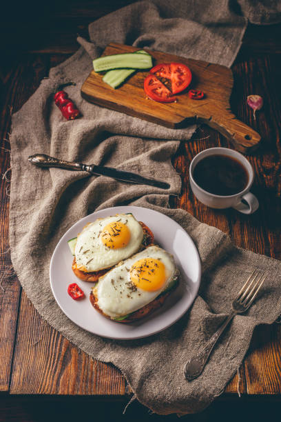 istock Breakfast toasts with vegetables and fried eggs with cup of coffee 1095083258