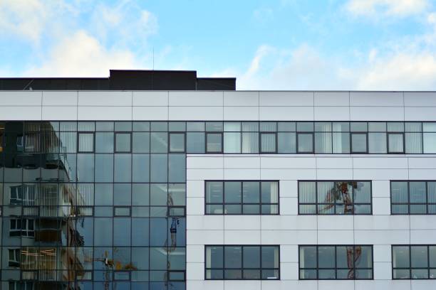 istock Modern building with reflected sky and cloud in glass window 1095085030