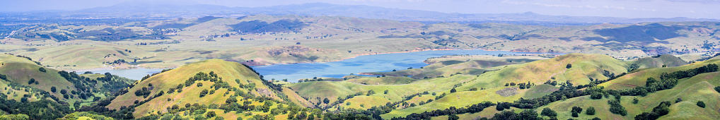 Panoramic view of San Antonio reservoir and the surrounding green hills, Sunol, Alameda county, San Francisco bay area, California