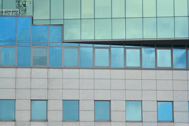istock Modern building with reflected sky and cloud in glass window 1095091494