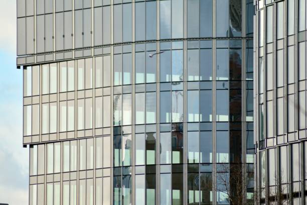 istock Modern building with reflected sky and cloud in glass window 1095092464