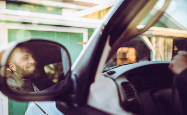 istock Man driving a vehicle, cheerful candid image 1095103870