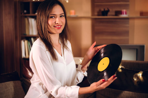 istock Woman with old vinyl record 1095105378