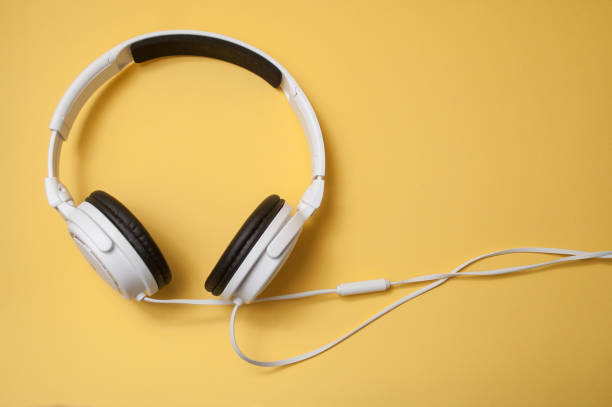 istock white headphones on yellow background 1095109640