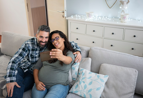Mature couple at home, expecting baby