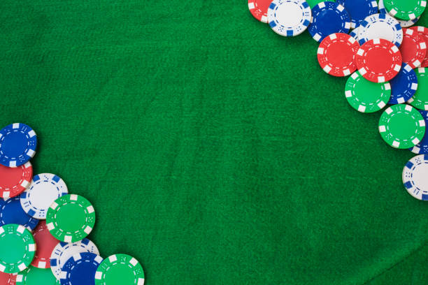 istock Colorful gambling chips on green felt background with copy space. 1095122090