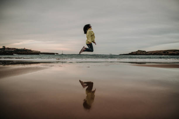 istock Woman jumping and her reflection 1095124308