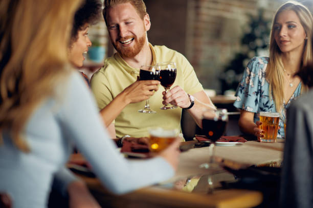 istock Friends making a toast while sitting in restaurant. 1095127642