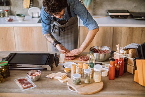 istock Chef Forming Raw Burgers 1095131232