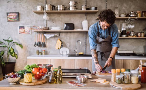 istock Male Chef Chopping Meat For Burger Preparation 1095131470