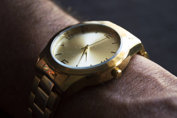 Closeup shot of an unrecognizable businessman checking the time on his wrist watch
