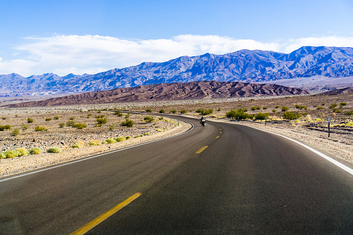 Driving through Death Valley National Park on clear morning, California