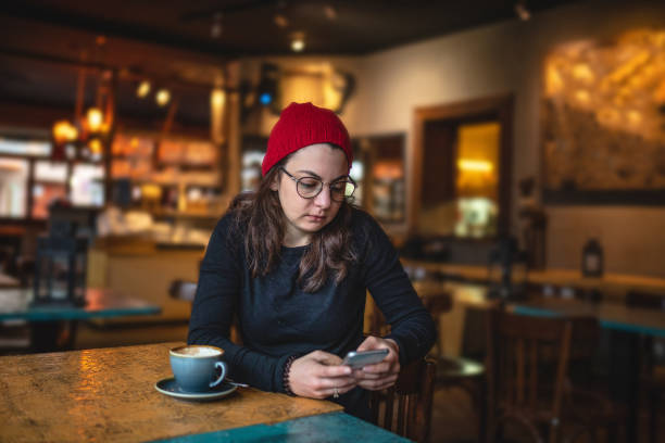istock Hipster girl scrolling through social media while drinking coffee 1095144920