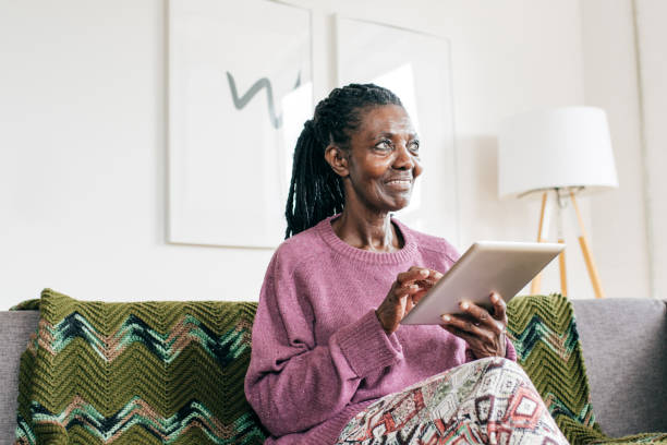istock Smiling senior  and caregiver  with tablet 1095145590
