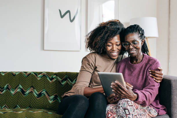 istock Smiling senior  and caregiver  with tablet 1095145598