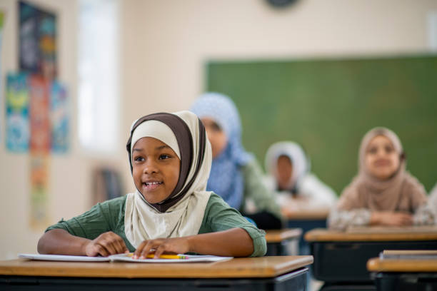 istock Muslim girls sitting in class 1095148230