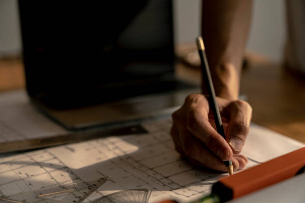 istock architect or civil engineer during drawing home or building in office on working table with office stationary , laptop ,color pallette sampling. 1095149846