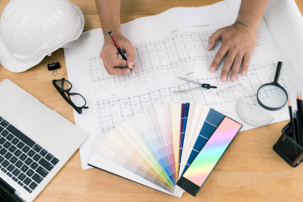 istock architect or civil engineer during drawing home or building in office on working table with office stationary , laptop ,color pallette sampling. 1095149852