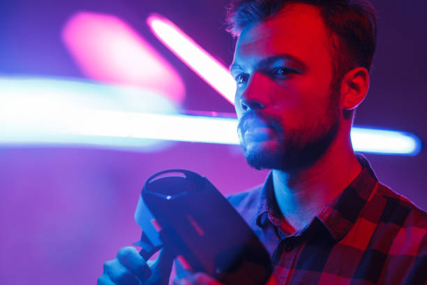 istock Stylish man with goggles in neon 1095150200