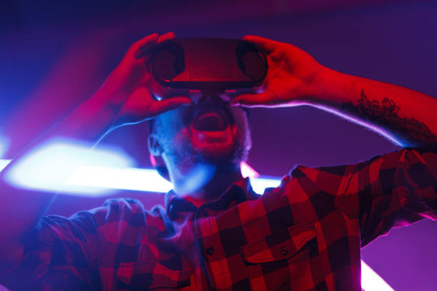 istock Expressive man gaming in VR glasses 1095150234