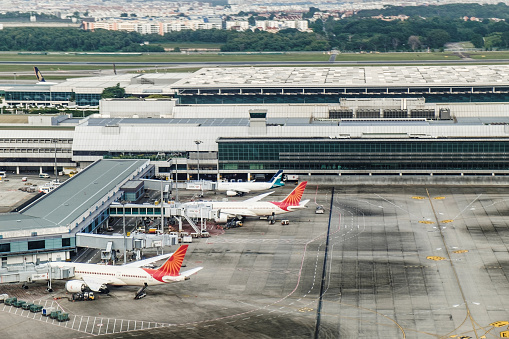Singapore - January 20, 2018: Airplanes docked at Changi International Airport in Singapore, view of the airport building from above