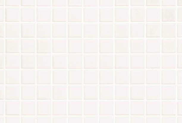 istock White or Cream ceramic wall and floor tiles abstract background. Design geometric mosaic texture for the decoration of the bedroom. Simple seamless pattern for backdrop advertising banner poster or web 1095153702
