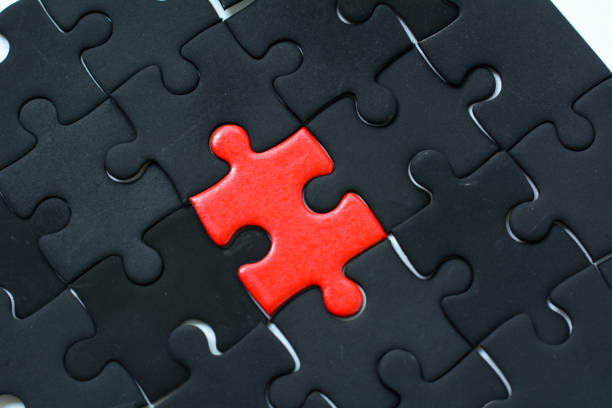 istock Red jigsaw puzzle with black jigsaw color background 1095159672
