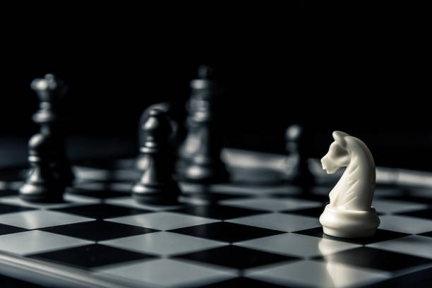 istock Chess board. White horse threatens black opponent's chess 1095168668
